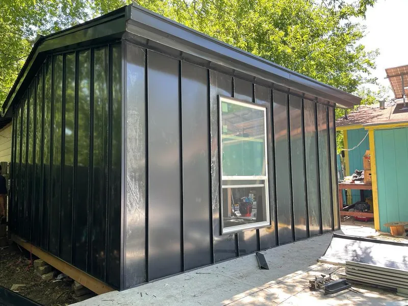 Black standing seam metal wall panels for Metal Roof Installation in Winter Beach