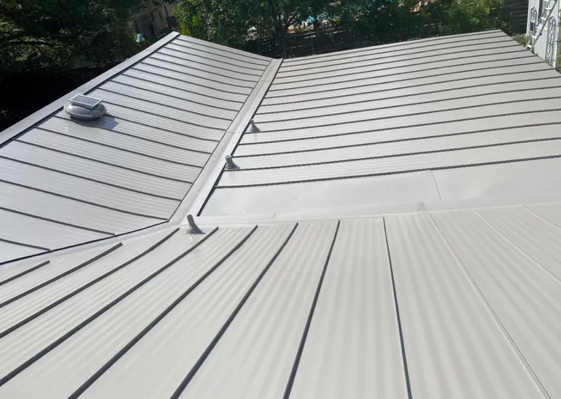 Solar attic fan installed on a metal roof for Roof Ventilation in Winter Beach